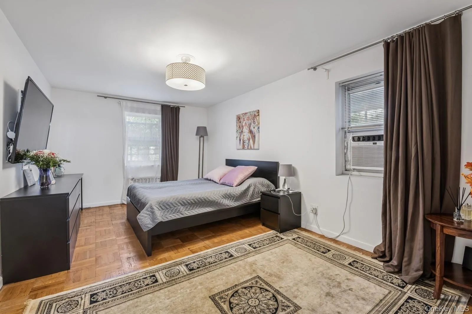 Bedroom featuring baseboards and cooling unit Bedroom featuring baseboards and cooling unit