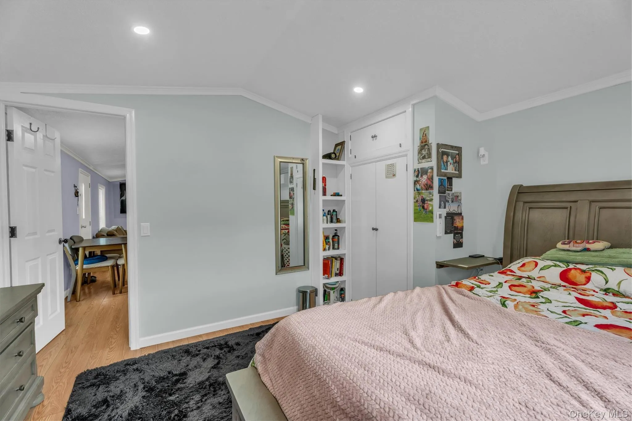Bedroom with ornamental molding, light wood-type flooring, recessed lighting, and lofted ceiling Bedroom with ornamental molding, light wood-type flooring, recessed lighting, and lofted ceiling