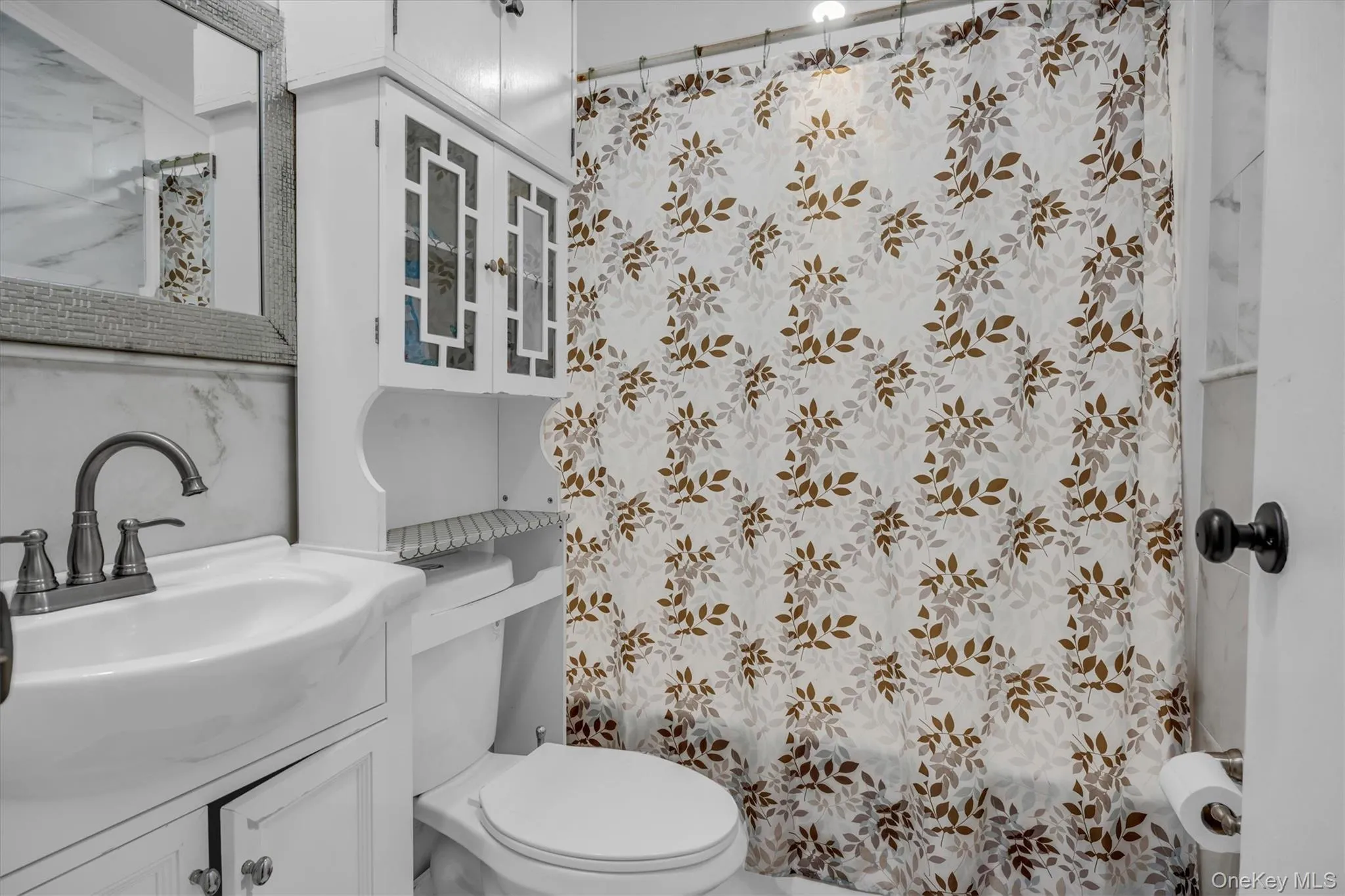 Bathroom featuring vanity and a shower with curtain Bathroom featuring vanity and a shower with curtain