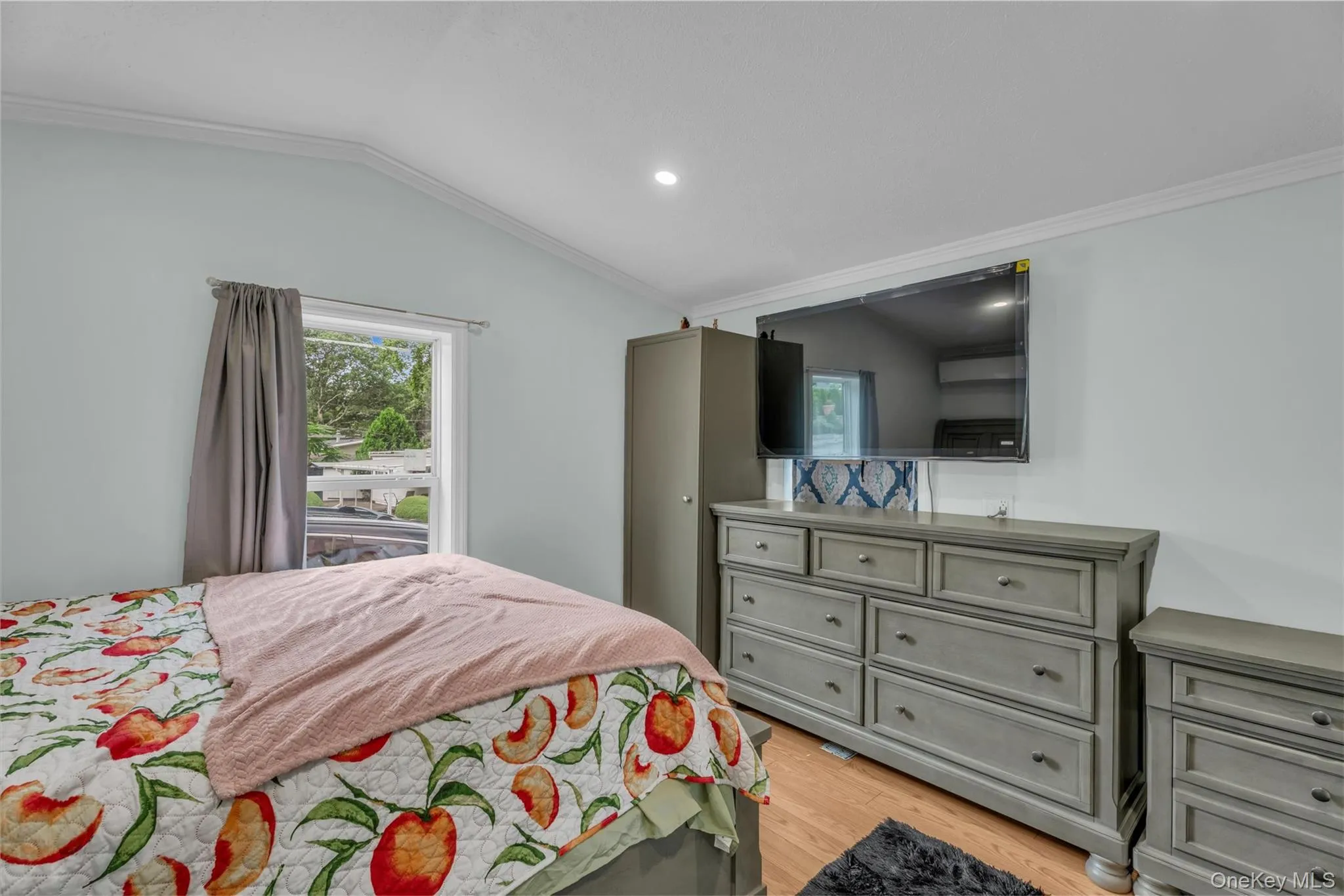 Bedroom featuring ornamental molding, lofted ceiling, light wood-style flooring, and recessed lighting Bedroom featuring ornamental molding, lofted ceiling, light wood-style flooring, and recessed lighting