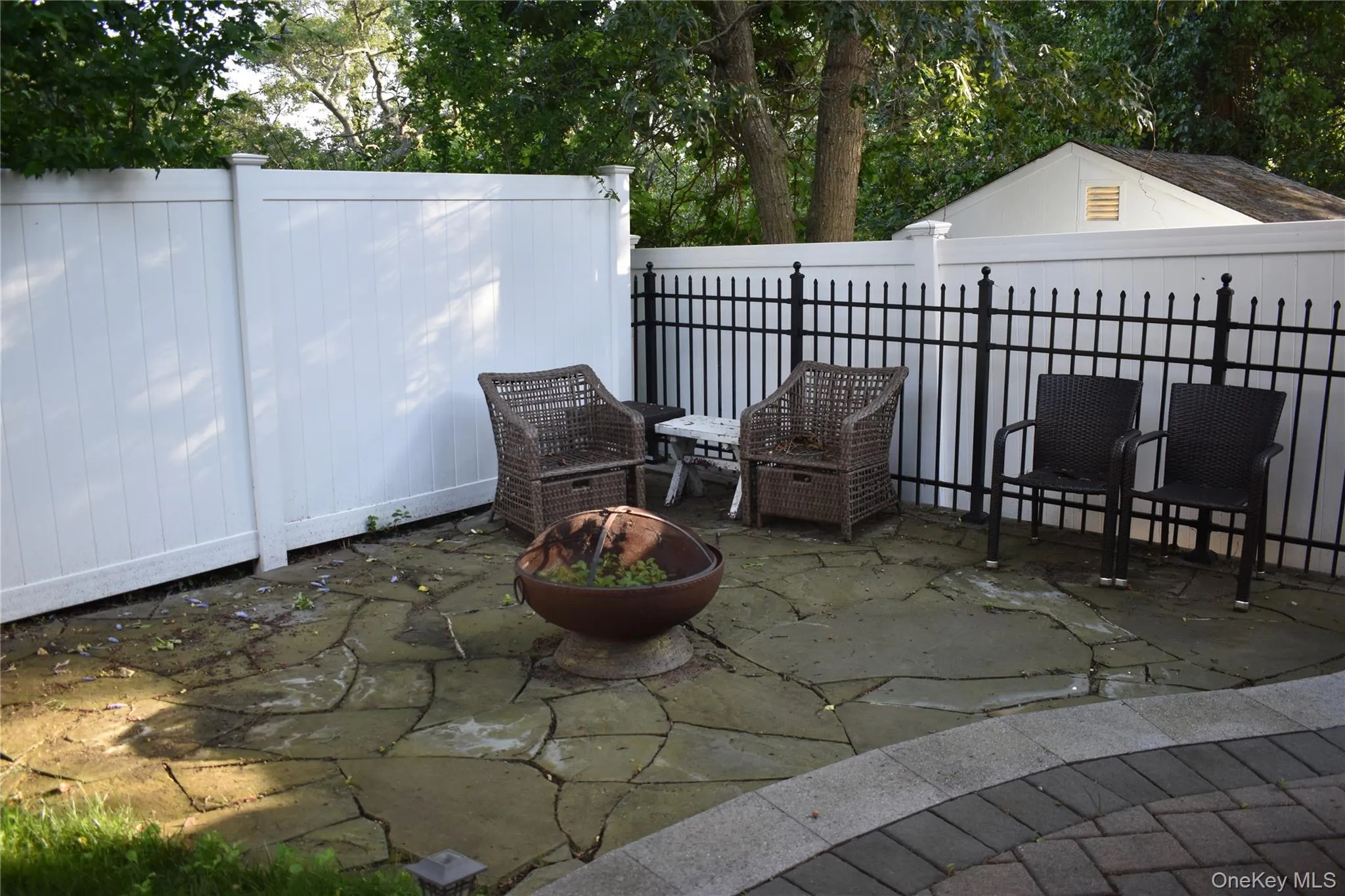 Fenced backyard with a patio area Fenced backyard with a patio area