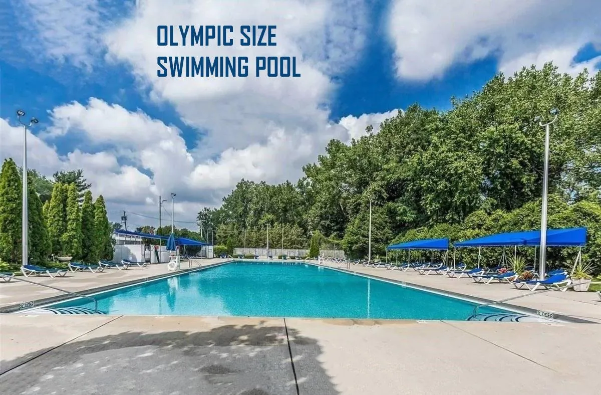 Community pool with a patio area Community pool with a patio area