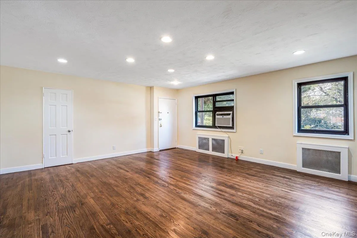 Living room with wood finished floors, and recessed lighting Living room with wood finished floors, and recessed lighting