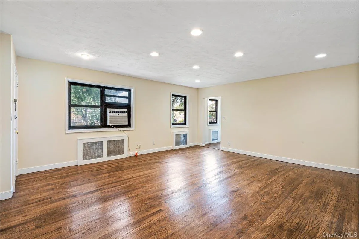 Living room with wood finished floors, and recessed lighting Living room with wood finished floors, and recessed lighting