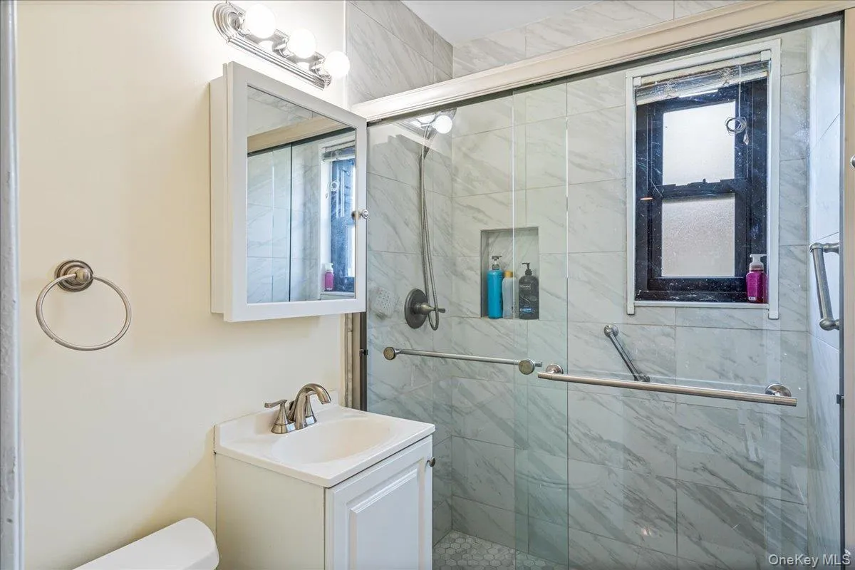 Bathroom with shower stall Bathroom with shower stall