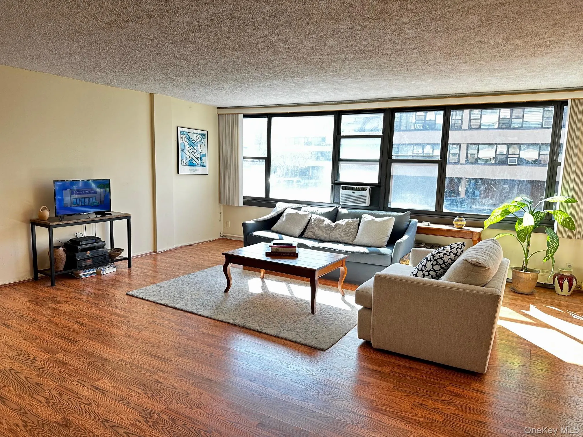 Living area with a textured ceiling and wood finished floors Living area with a textured ceiling and wood finished floors