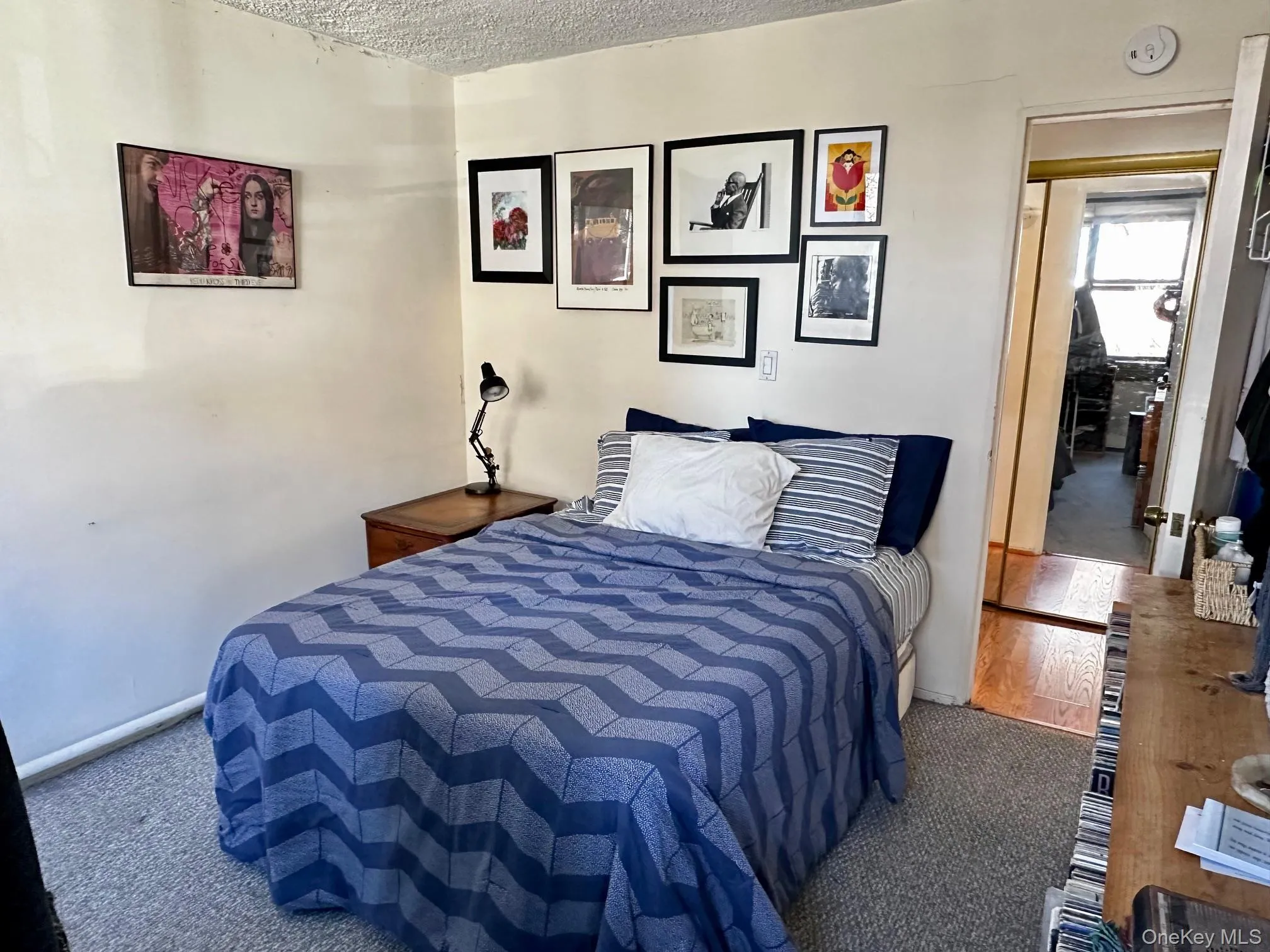 Bedroom featuring a textured ceiling and wood finished floors Bedroom featuring a textured ceiling and wood finished floors
