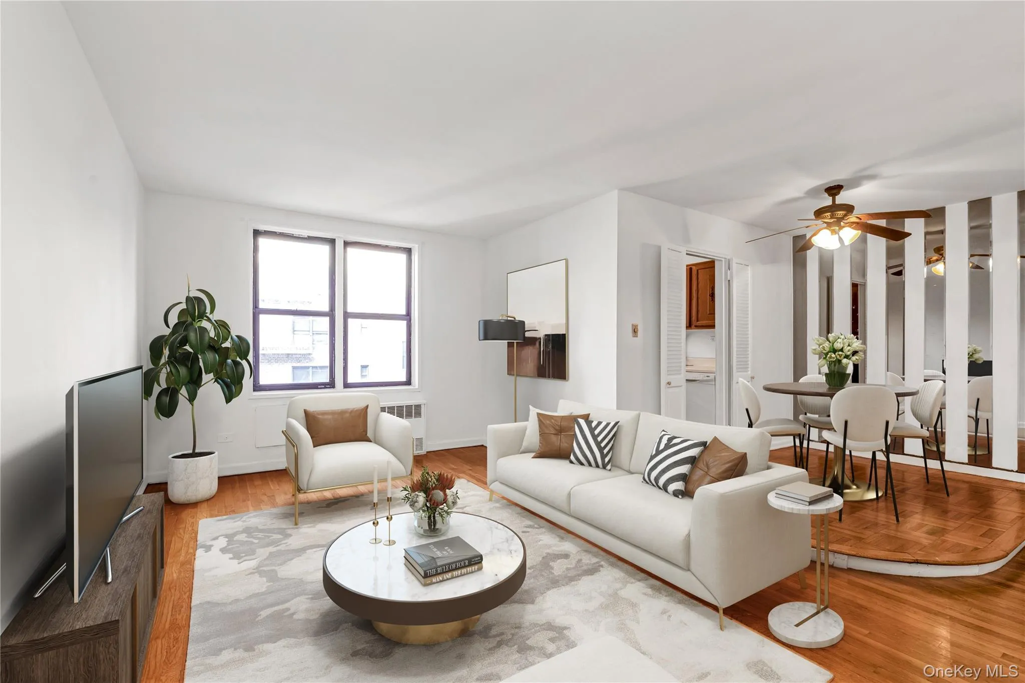 Living room featuring wood finished floors, radiator, and ceiling fan Living room featuring wood finished floors, radiator, and ceiling fan