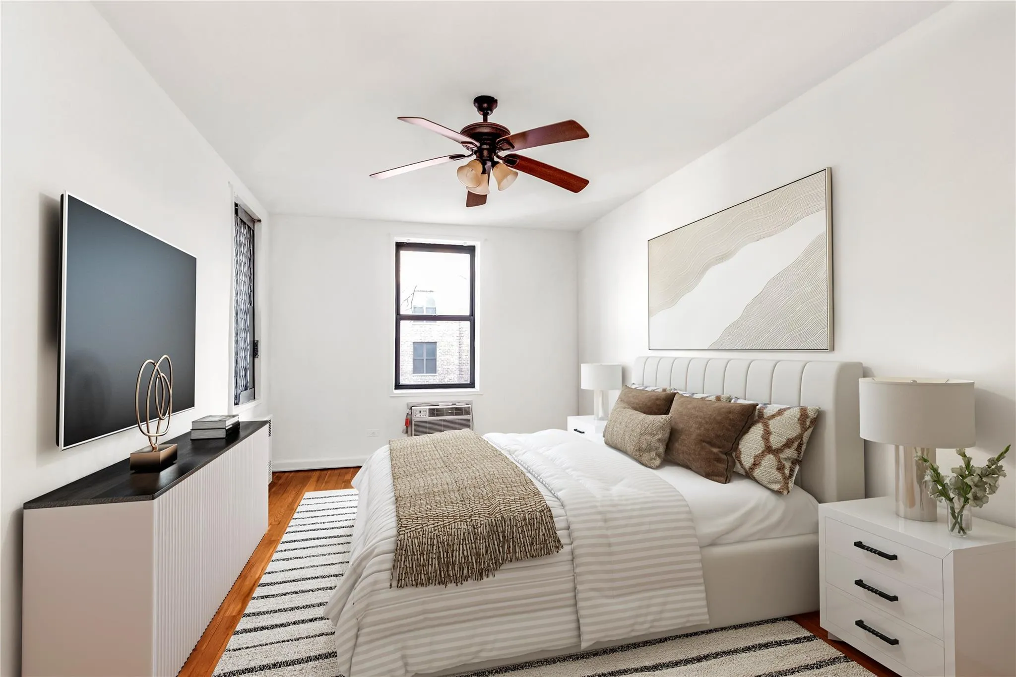 Bedroom with light wood finished floors and ceiling fan Bedroom with light wood finished floors and ceiling fan