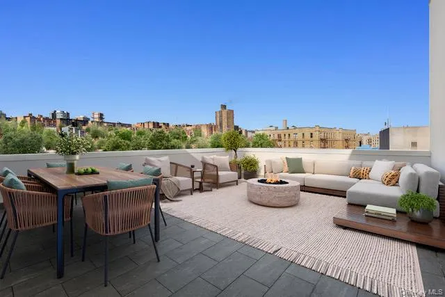 View of patio / terrace with outdoor dining space, an outdoor living space with a fire pit, and a city view View of patio / terrace with outdoor dining space, an outdoor living space with a fire pit, and a city view