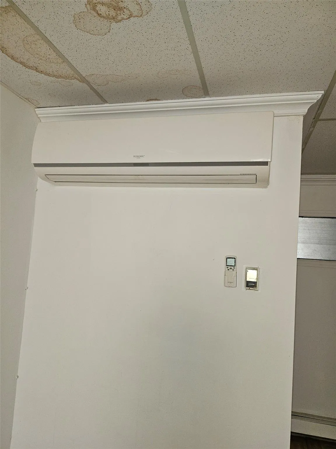 Laundry room with a wall mounted air conditioner and baseboard heating Laundry room with a wall mounted air conditioner and baseboard heating