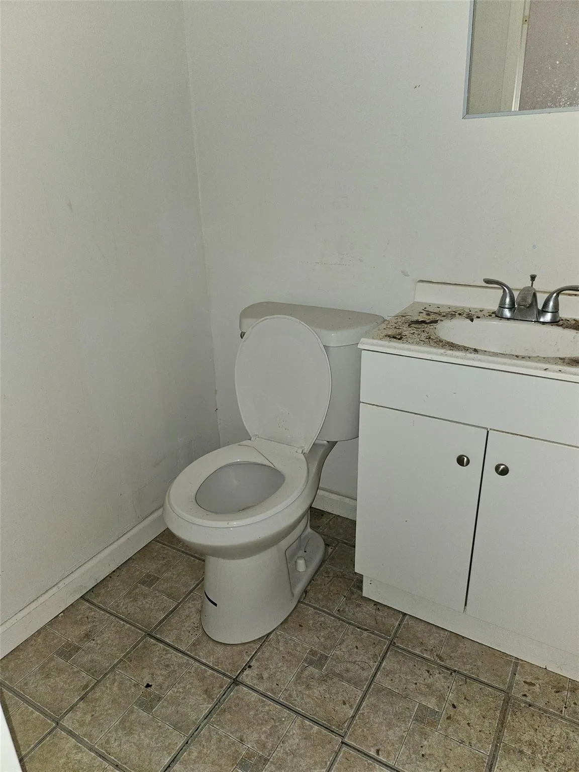 Bathroom featuring toilet and vanity Bathroom featuring toilet and vanity