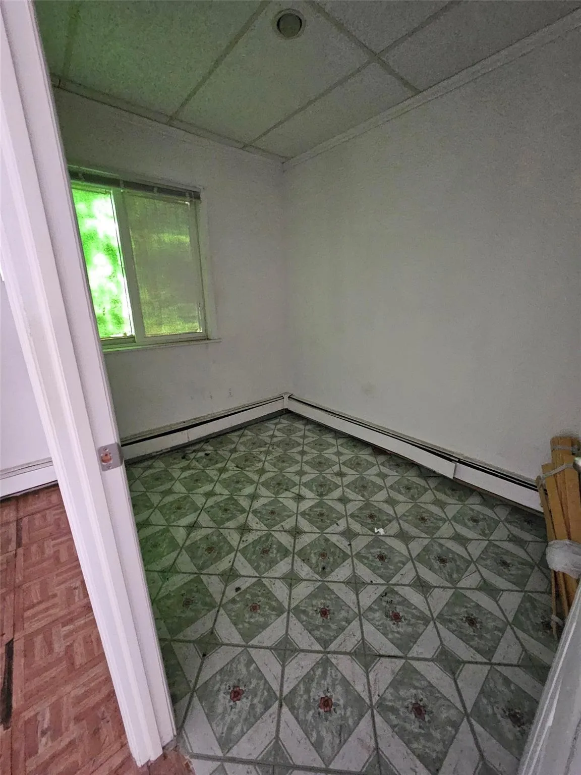 Spare room featuring a paneled ceiling and a baseboard radiator Spare room featuring a paneled ceiling and a baseboard radiator