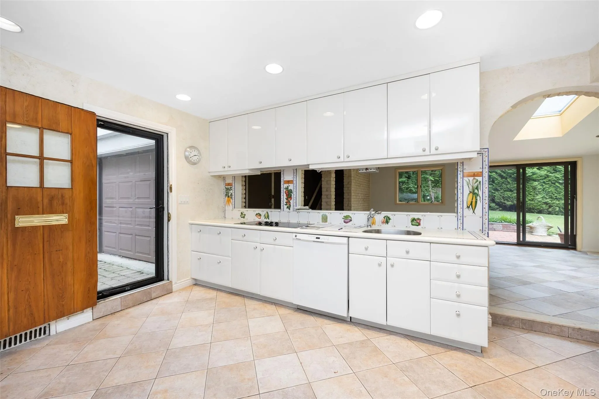 Kitchen featuring dishwasher, light countertops, white cabinetry, and recessed lighting Kitchen featuring dishwasher, light countertops, white cabinetry, and recessed lighting