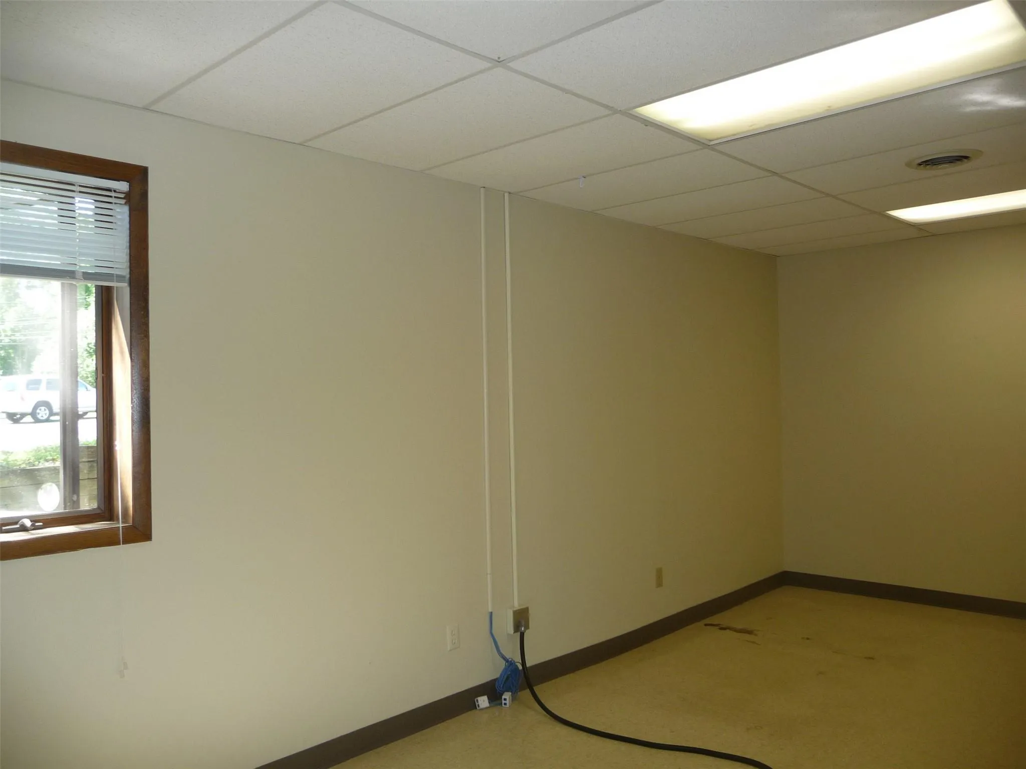 Unfurnished room featuring a paneled ceiling and baseboards Unfurnished room featuring a paneled ceiling and baseboards