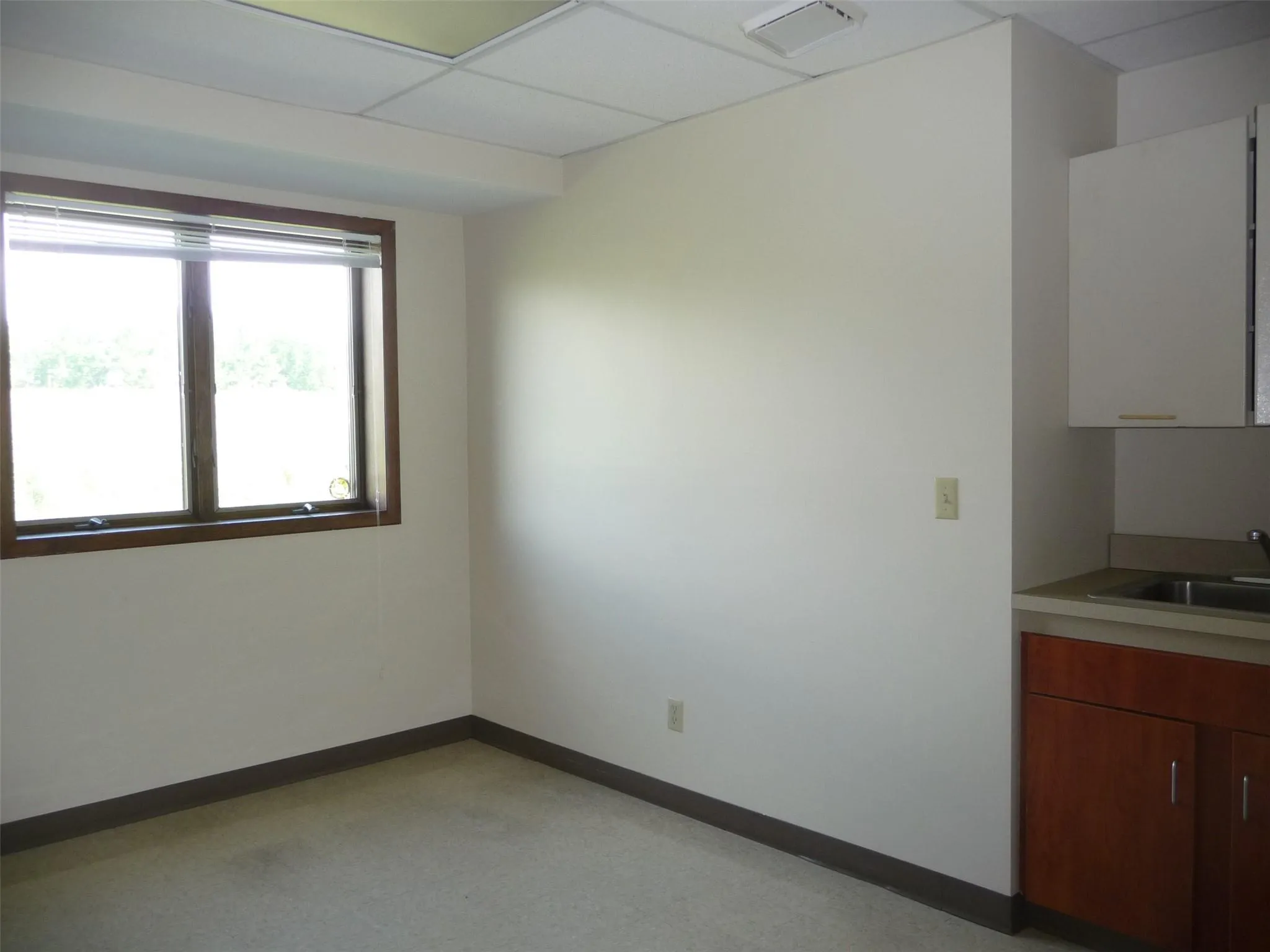 Spare room featuring baseboards and a paneled ceiling Spare room featuring baseboards and a paneled ceiling