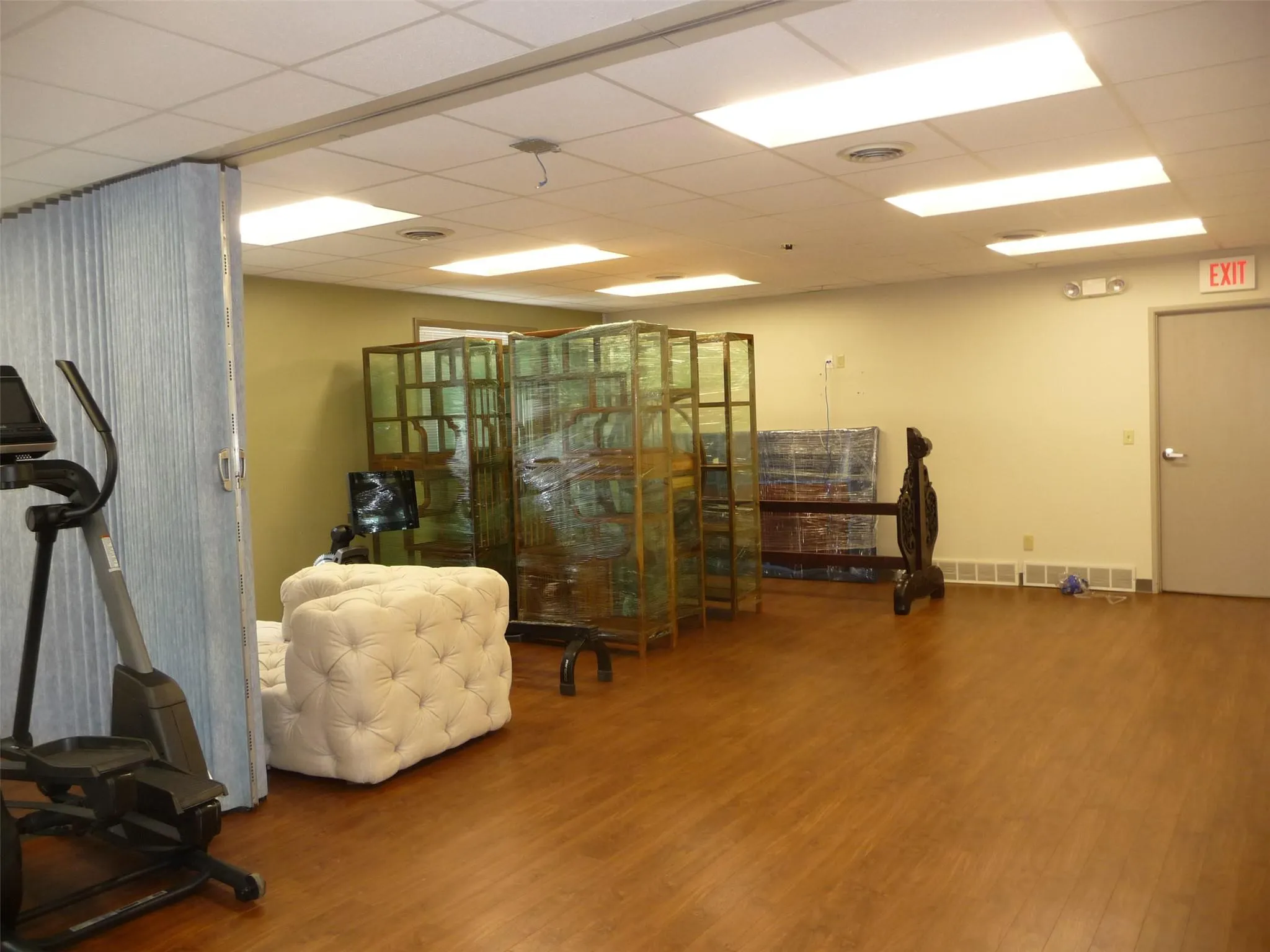 Office space featuring wood finished floors and a paneled ceiling Office space featuring wood finished floors and a paneled ceiling