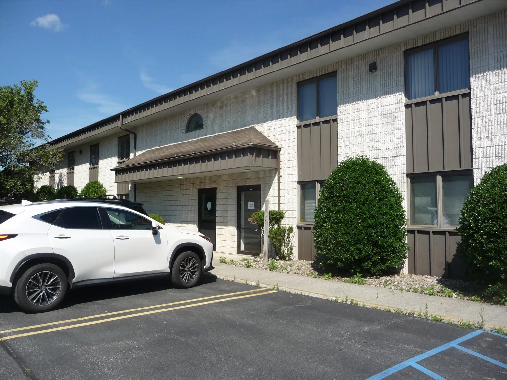 View of building exterior featuring uncovered parking View of building exterior featuring uncovered parking