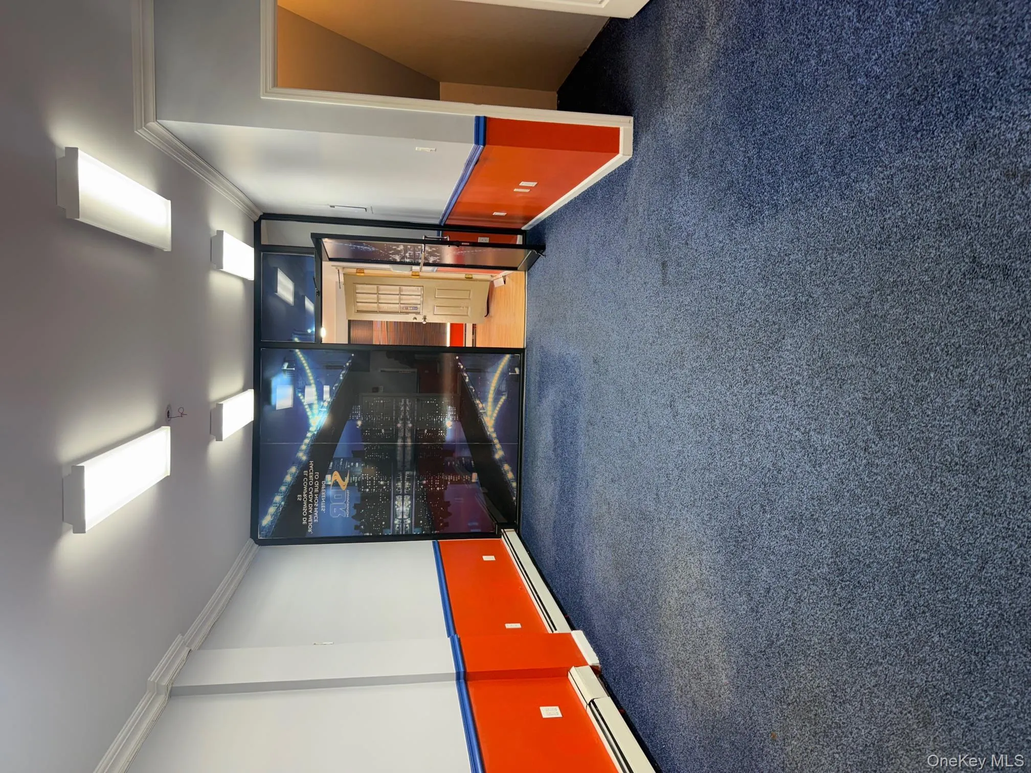 Carpeted cinema with crown molding and a baseboard radiator Carpeted cinema with crown molding and a baseboard radiator