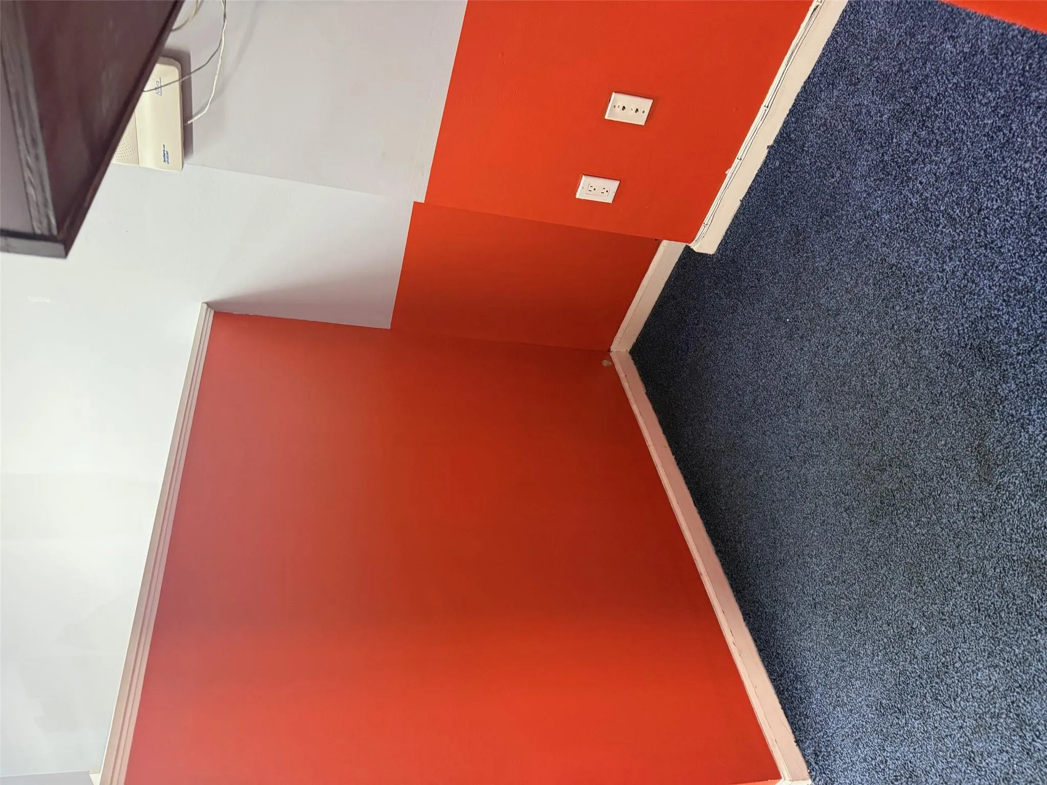 Bonus room with dark colored carpet and baseboards Bonus room with dark colored carpet and baseboards