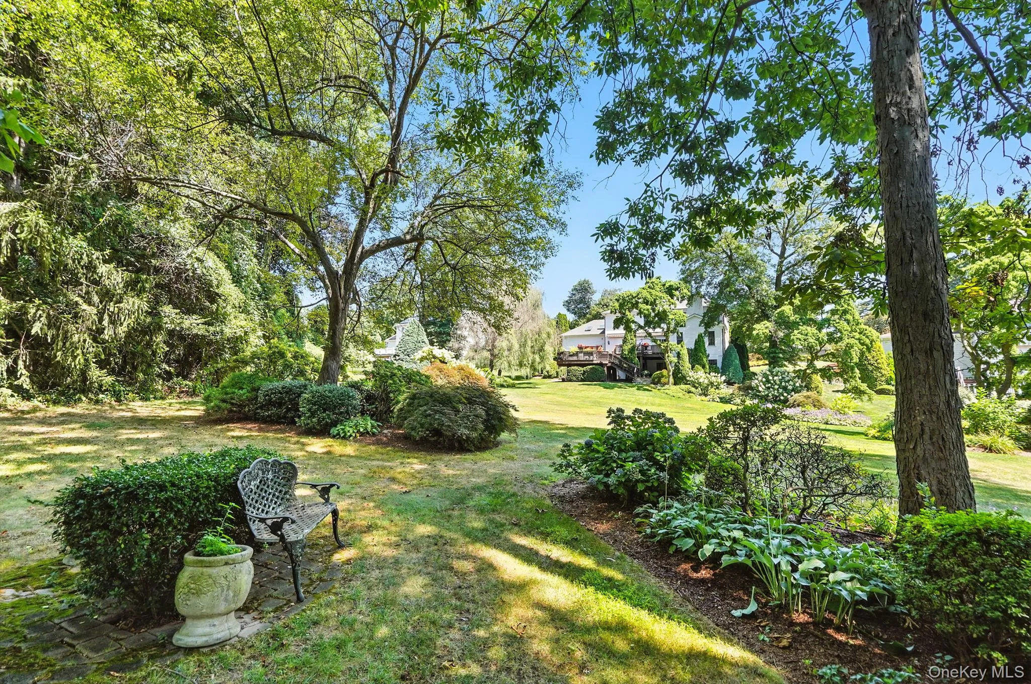 View of green lawn featuring view of scattered trees View of green lawn featuring view of scattered trees