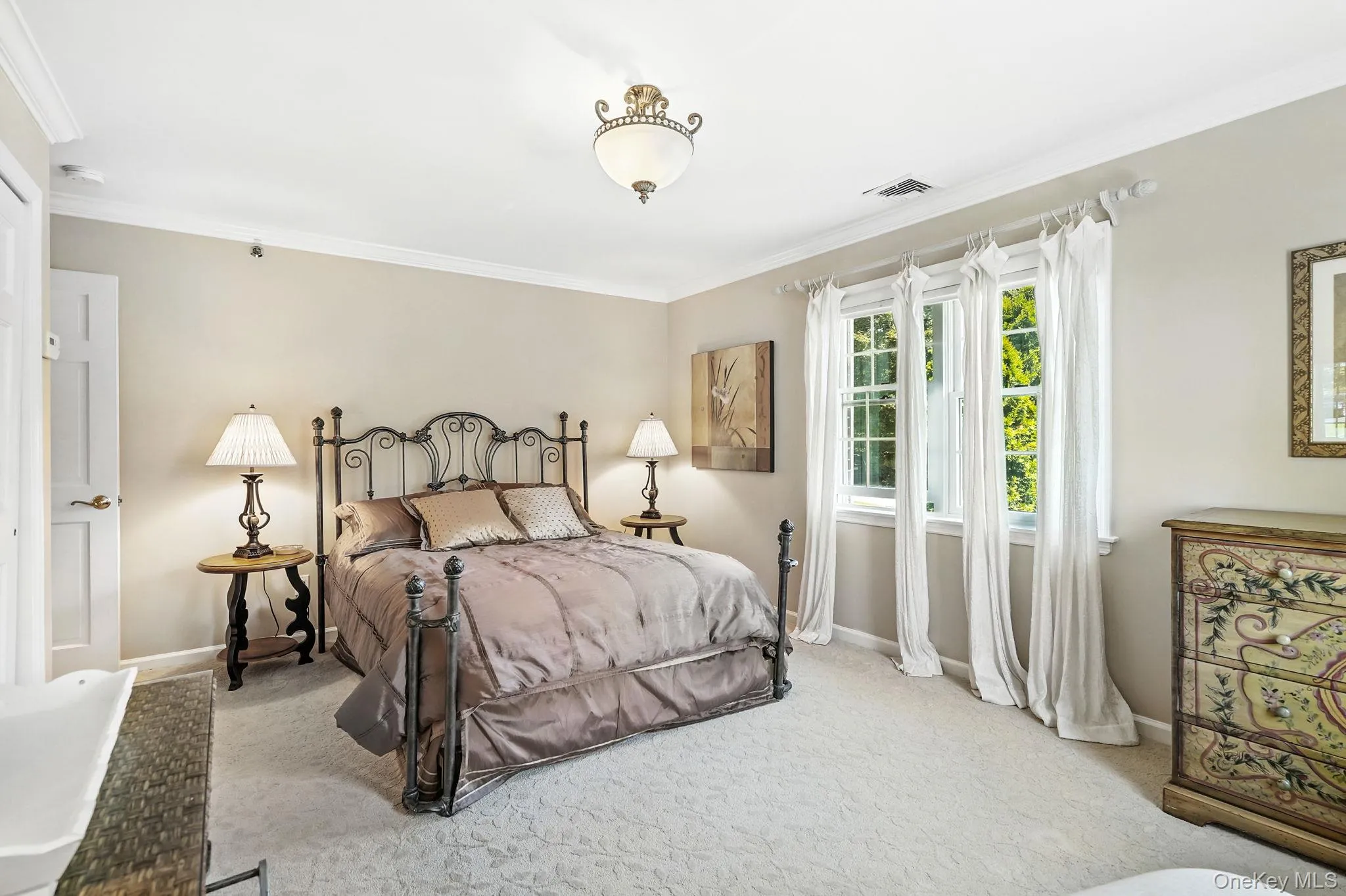Bedroom with ornamental molding and carpet floors Bedroom with ornamental molding and carpet floors