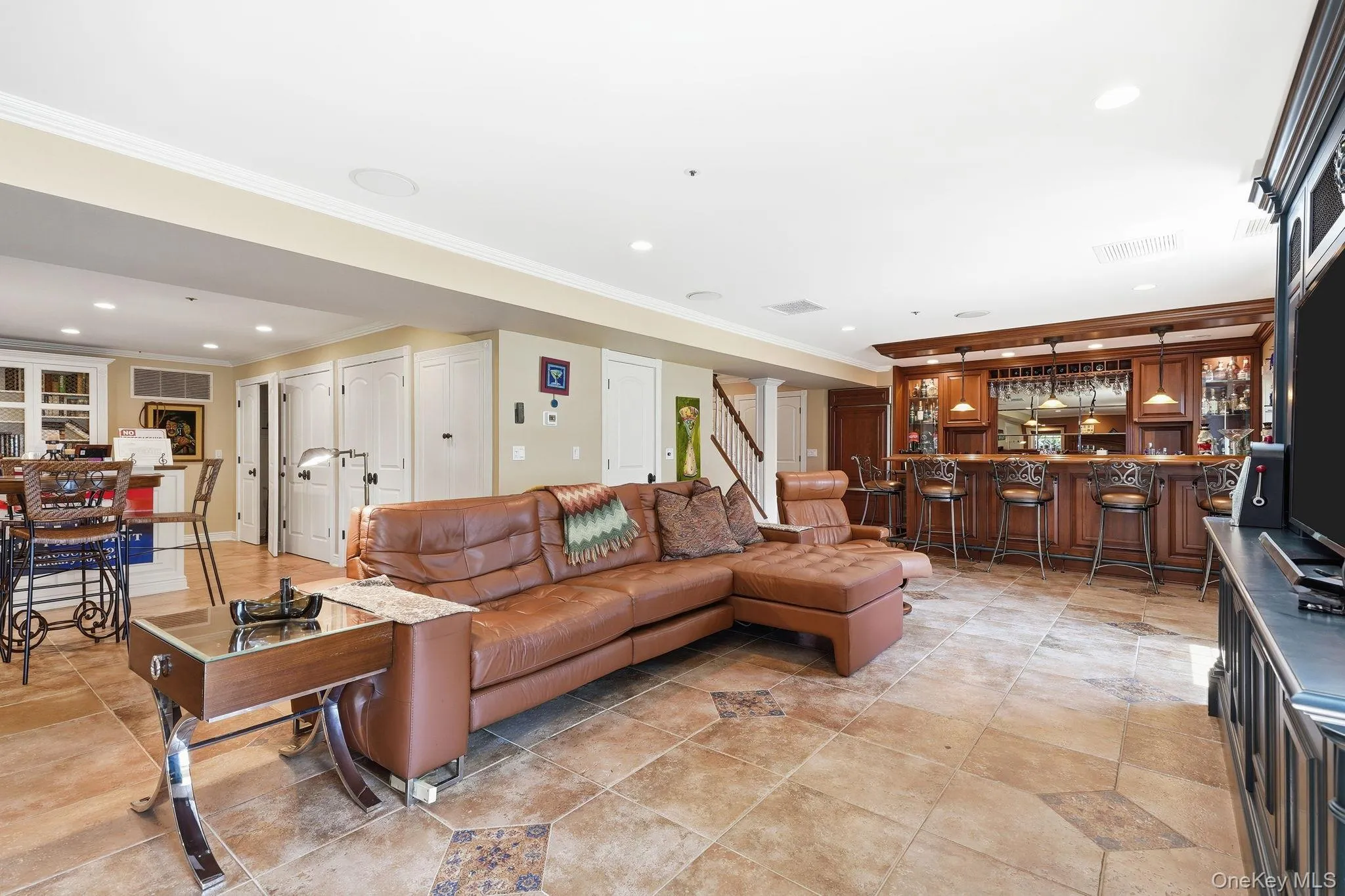 Family room with gas fireplace in terrace level with Bar and walk-out access to patio. Family room with gas fireplace in terrace level with Bar and walk-out access to patio.