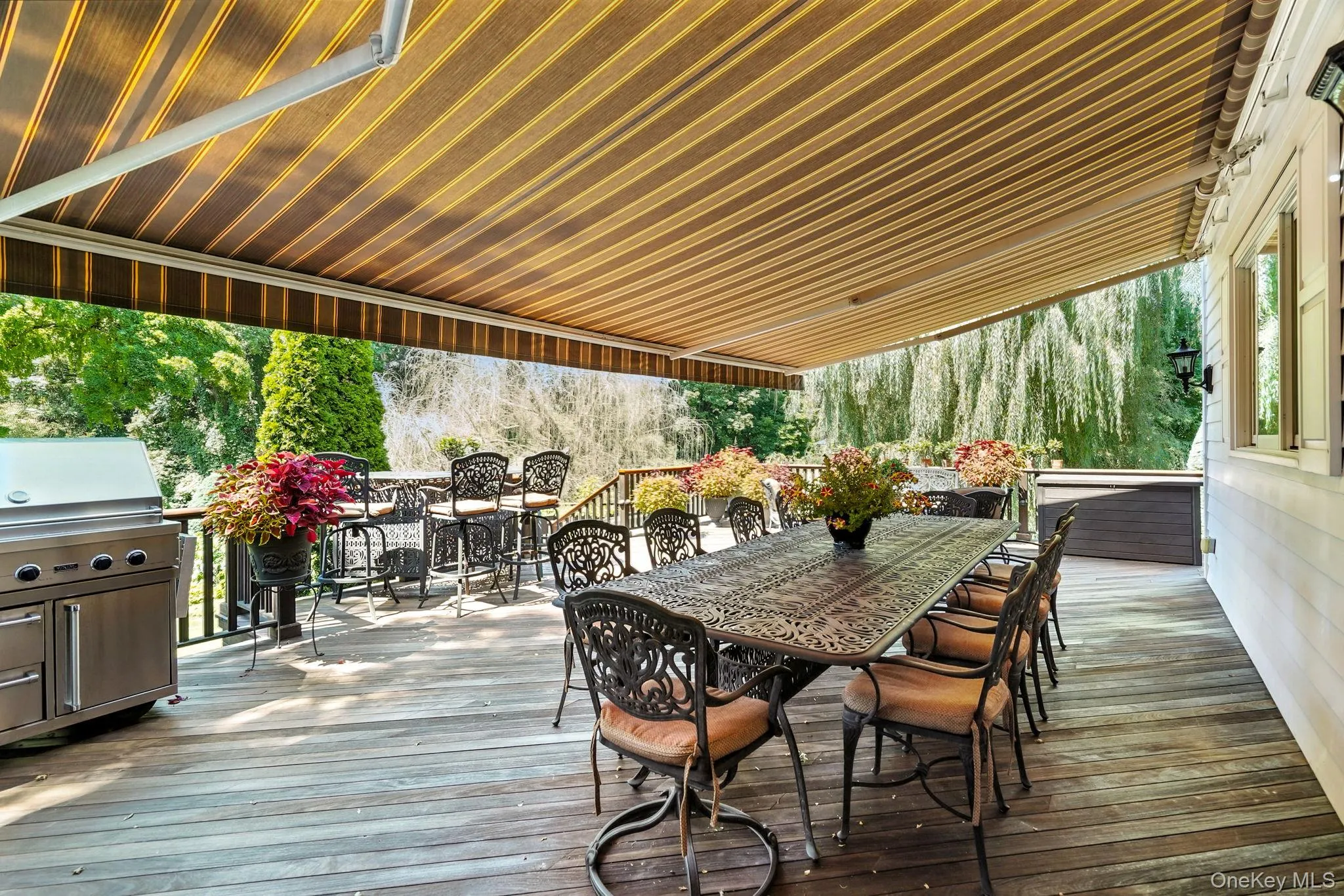 Wooden deck with outdoor dining area and grilling area Wooden deck with outdoor dining area and grilling area