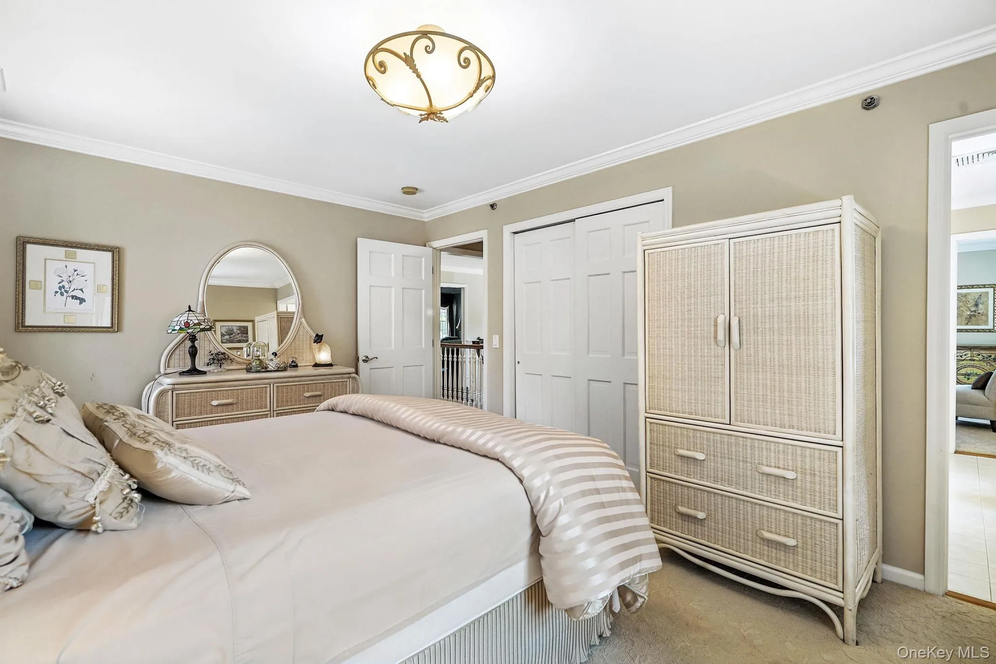 Carpeted bedroom with crown molding and a closet Carpeted bedroom with crown molding and a closet