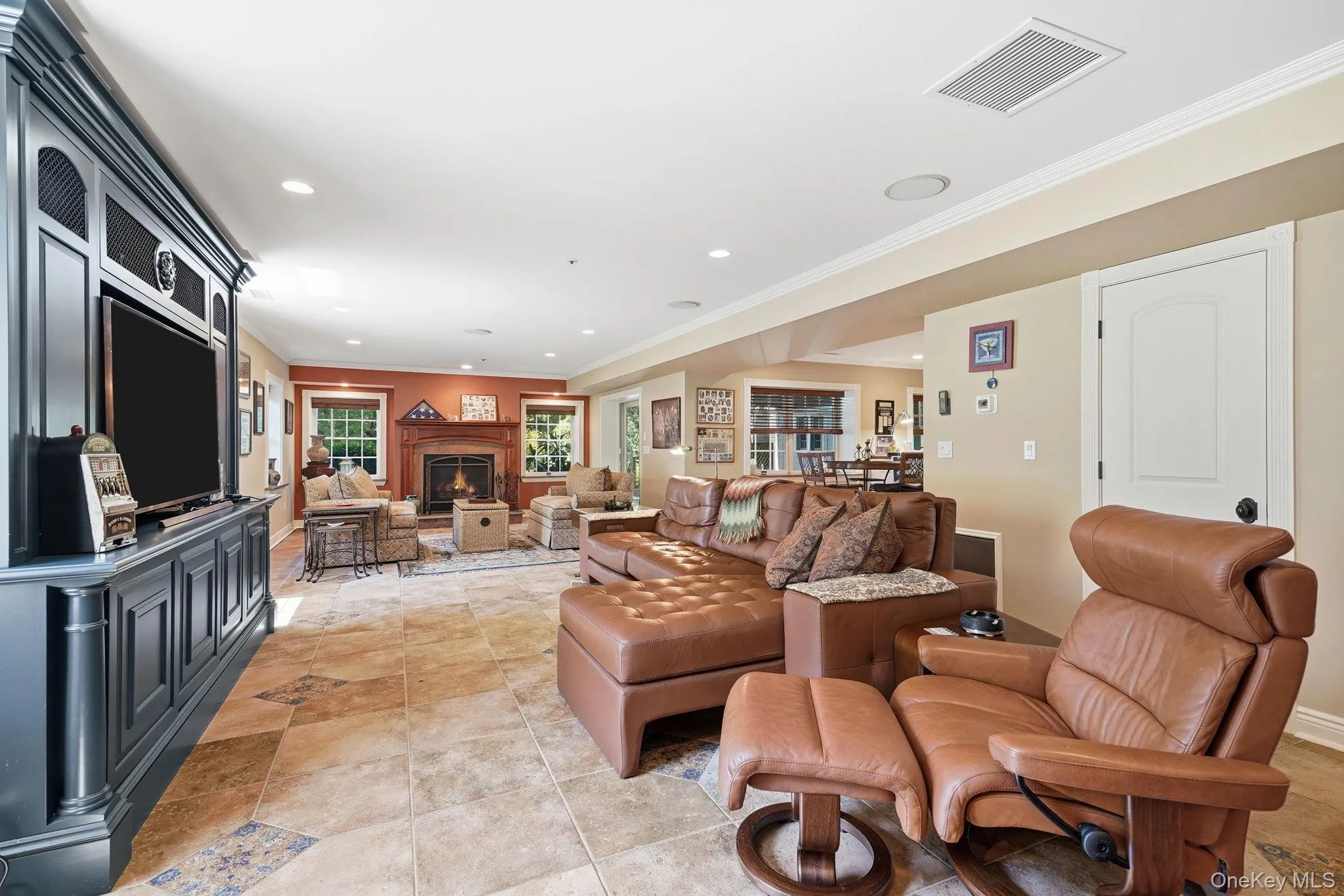 Family room with gas fireplace in terrace level with Bar and walk-out access to patio. Family room with gas fireplace in terrace level with Bar and walk-out access to patio.
