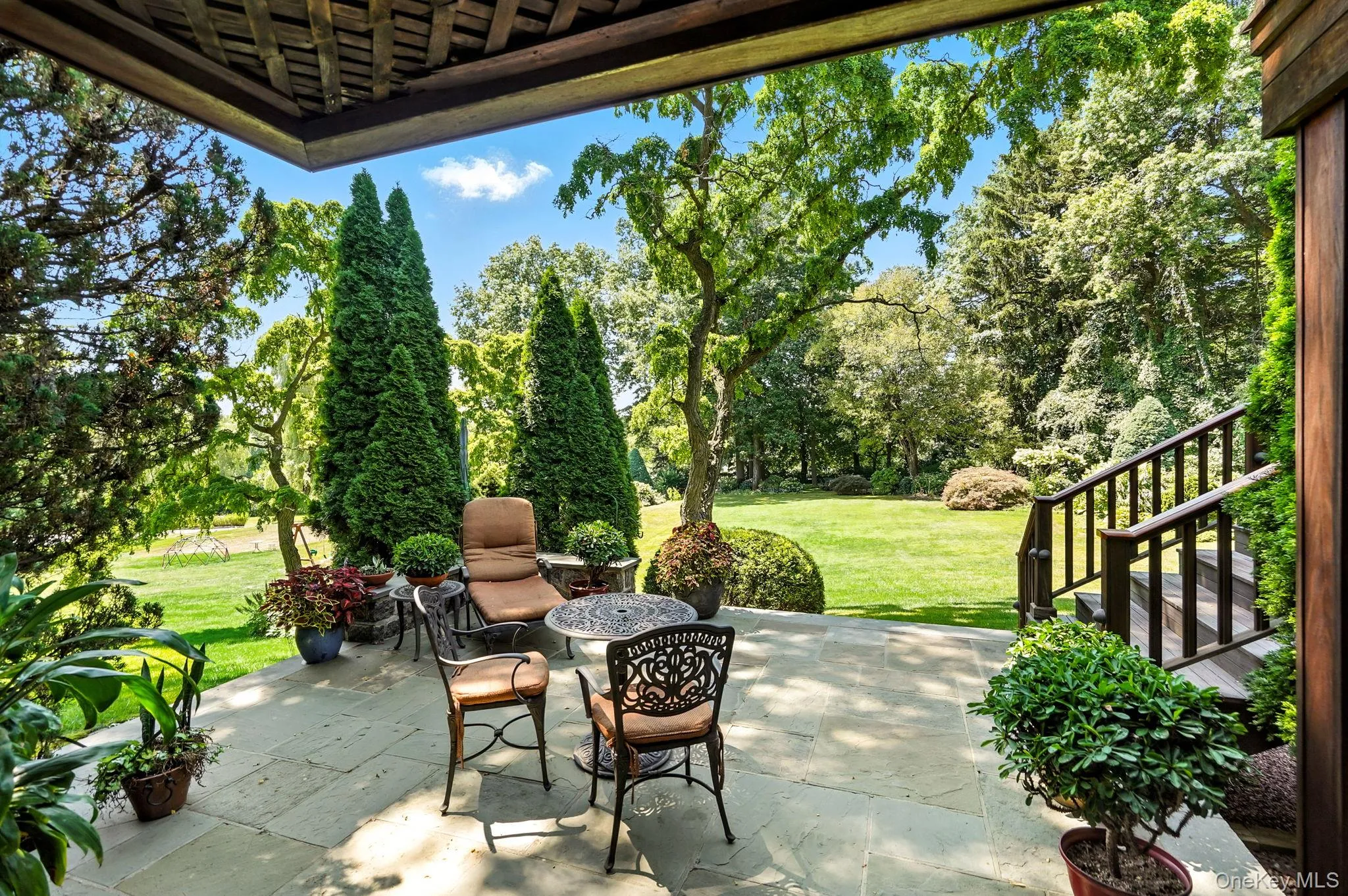 View of patio featuring view of wooded area View of patio featuring view of wooded area