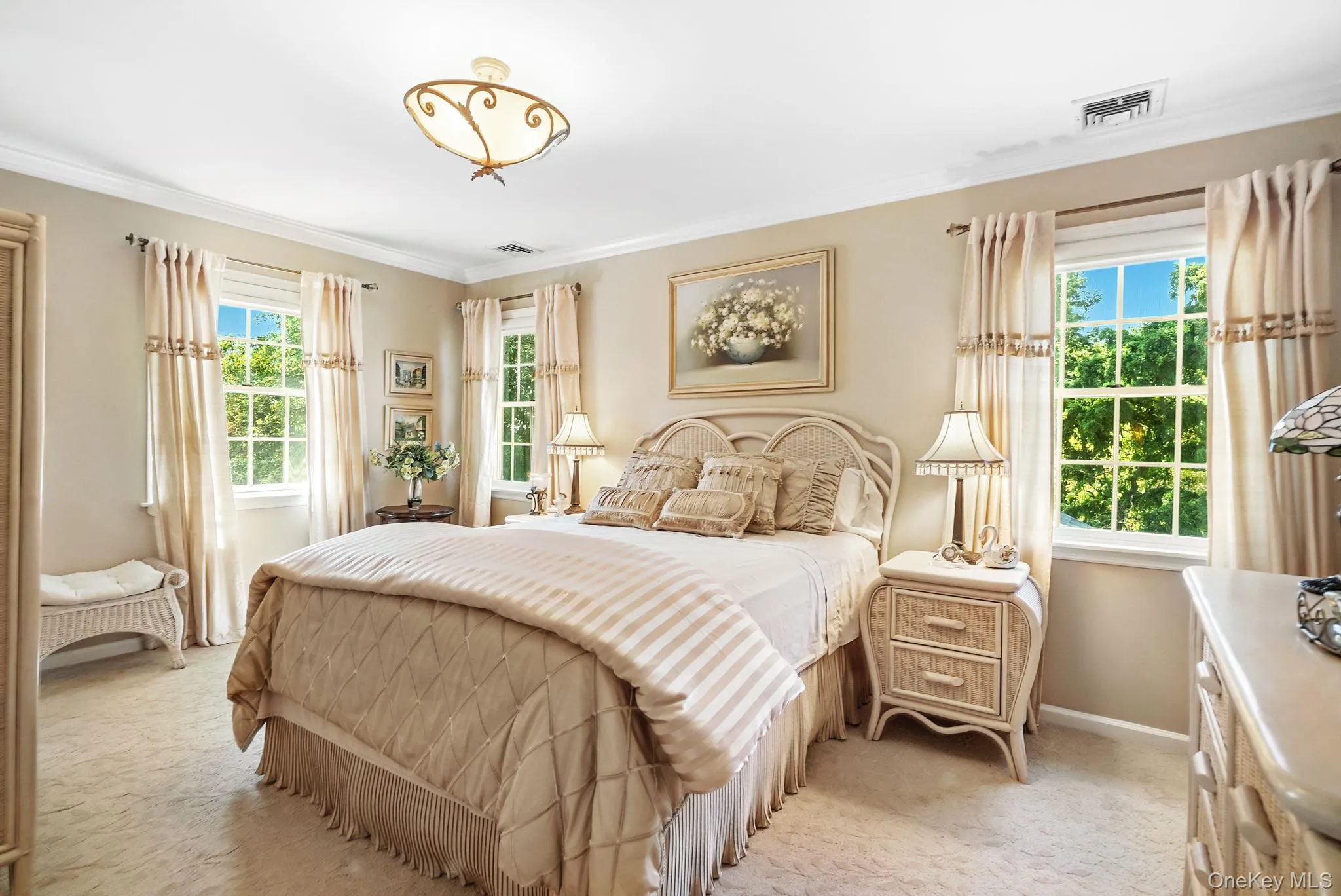 Bedroom featuring ornamental molding and light carpet Bedroom featuring ornamental molding and light carpet