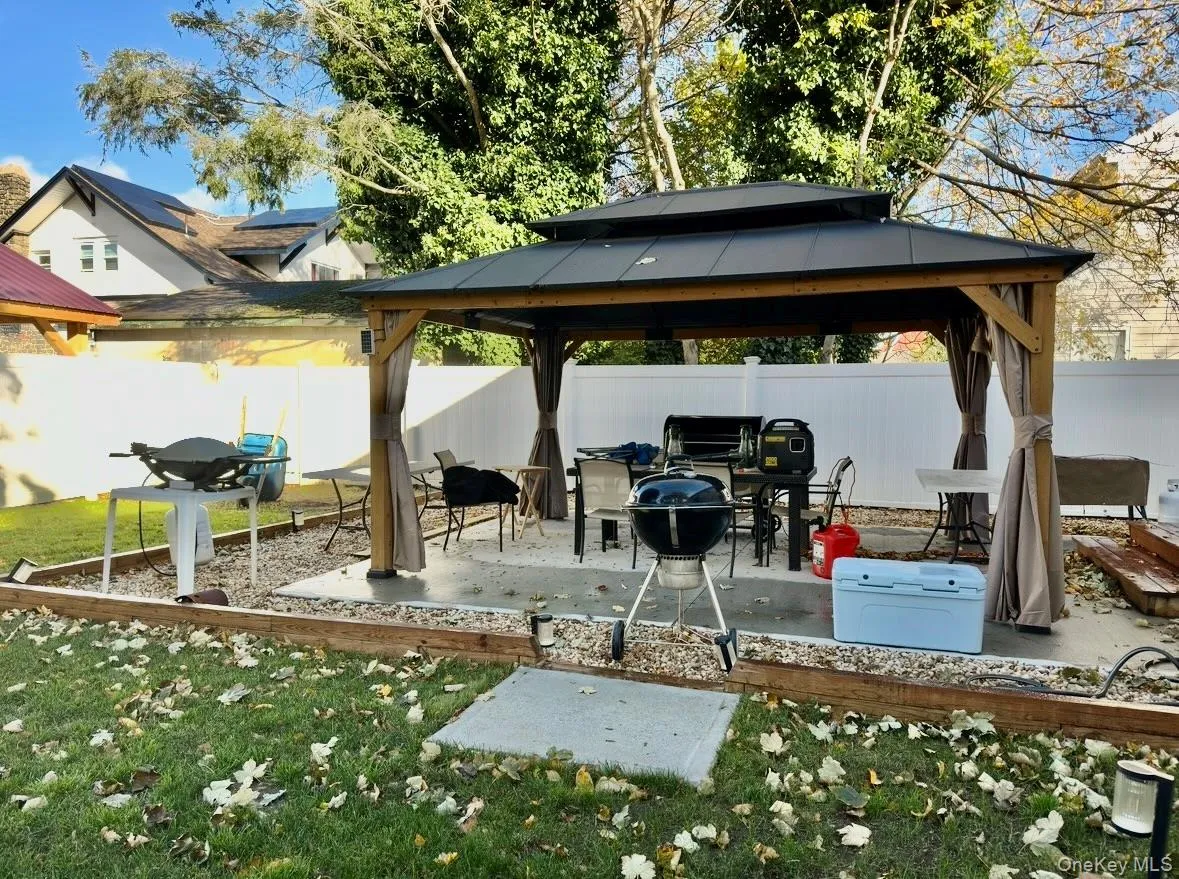 Fenced backyard with a patio area, a gazebo, and grilling area Fenced backyard with a patio area, a gazebo, and grilling area