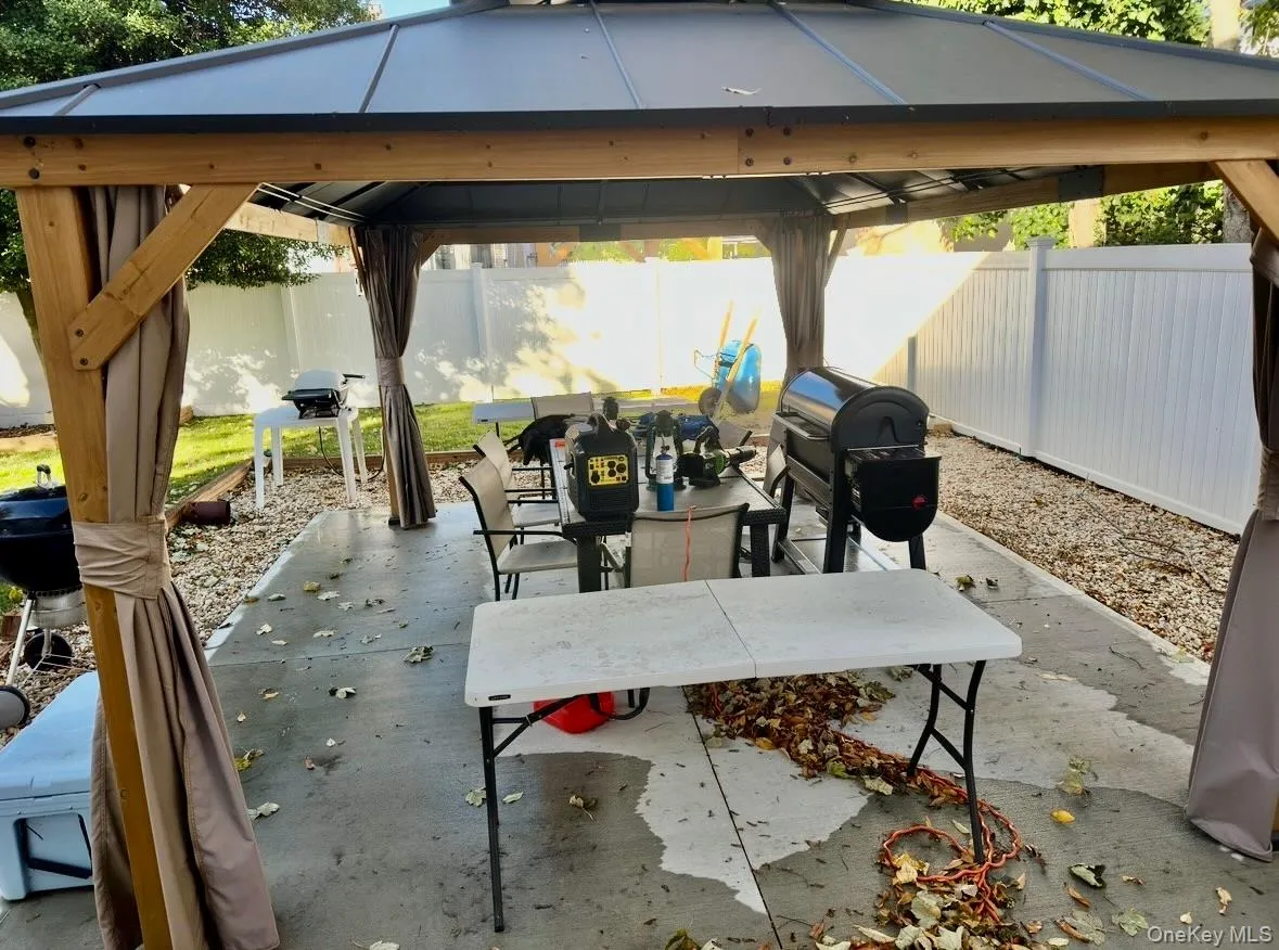 View of patio / terrace with a gazebo, outdoor dining space, and area for grilling View of patio / terrace with a gazebo, outdoor dining space, and area for grilling