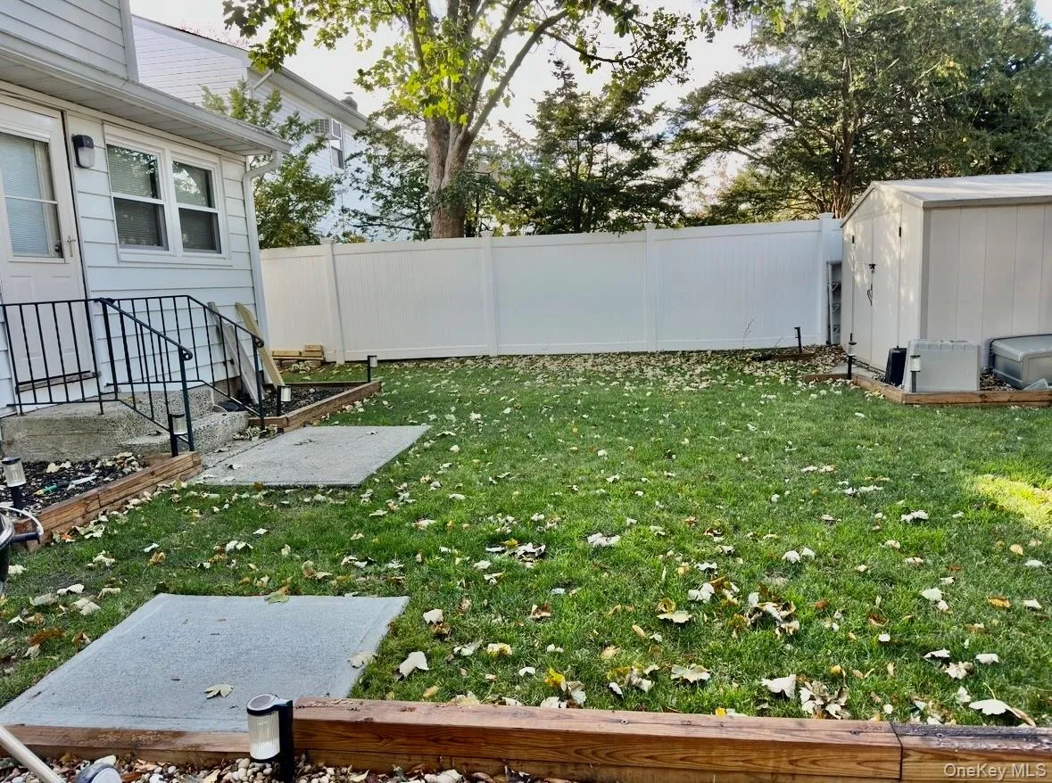 Fenced backyard featuring a shed Fenced backyard featuring a shed