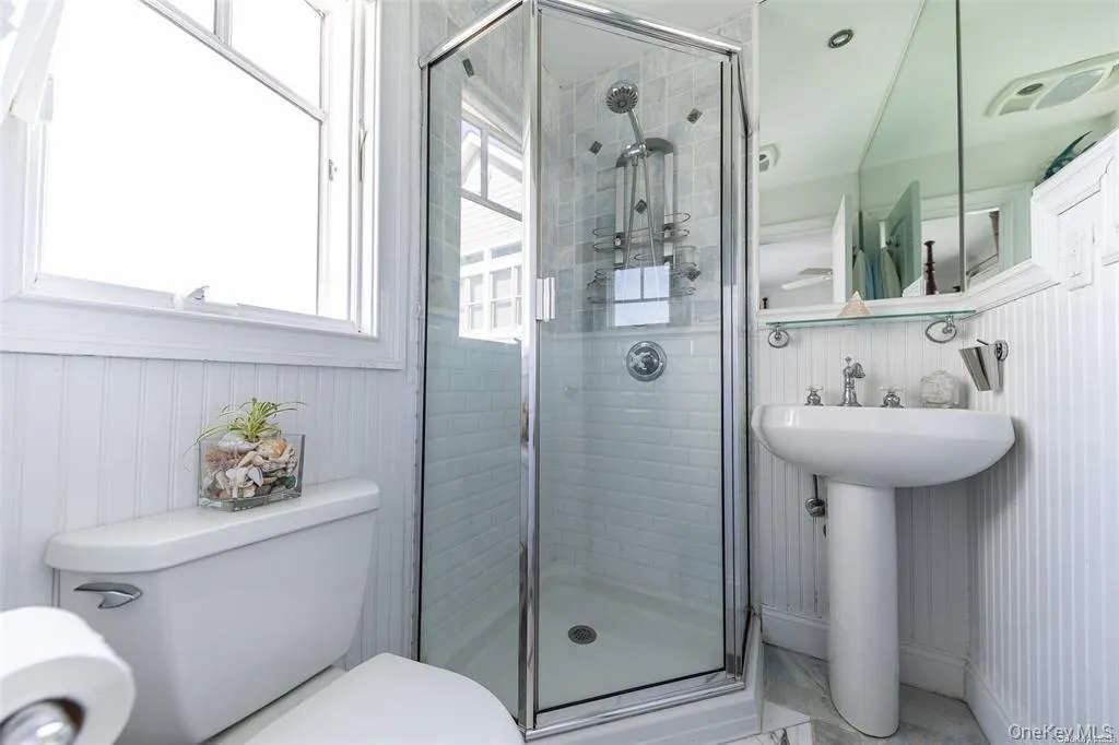 Primary Bathroom with toilet, a shower stall, and a sink Primary Bathroom with toilet, a shower stall, and a sink