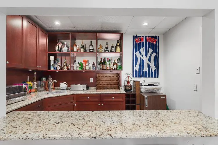 Indoor wet bar with a drop ceiling and recessed lighting Indoor wet bar with a drop ceiling and recessed lighting