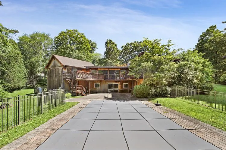 Back of property with a patio area, stairway, a fenced backyard, and a deck Back of property with a patio area, stairway, a fenced backyard, and a deck