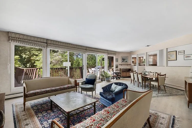 Living room with baseboard heating and wood finished floors Living room with baseboard heating and wood finished floors