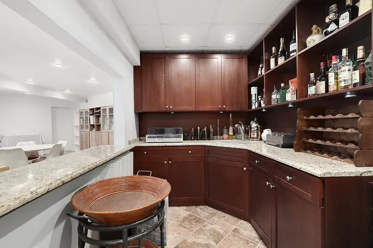 Bar with recessed lighting and a paneled ceiling Bar with recessed lighting and a paneled ceiling