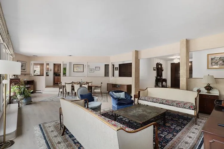 Living room featuring wood finished floors and baseboard heating Living room featuring wood finished floors and baseboard heating