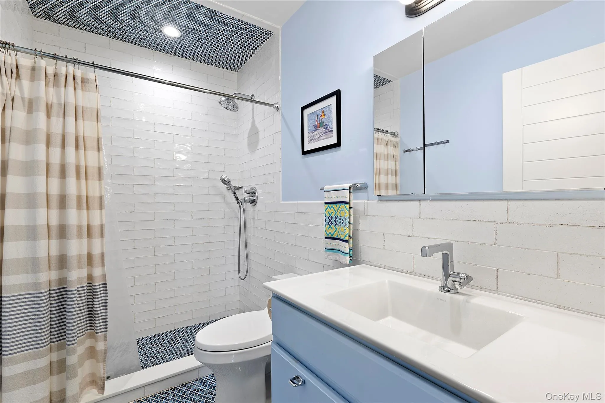 Full bathroom with vanity, tile walls, and a tile shower Full bathroom with vanity, tile walls, and a tile shower