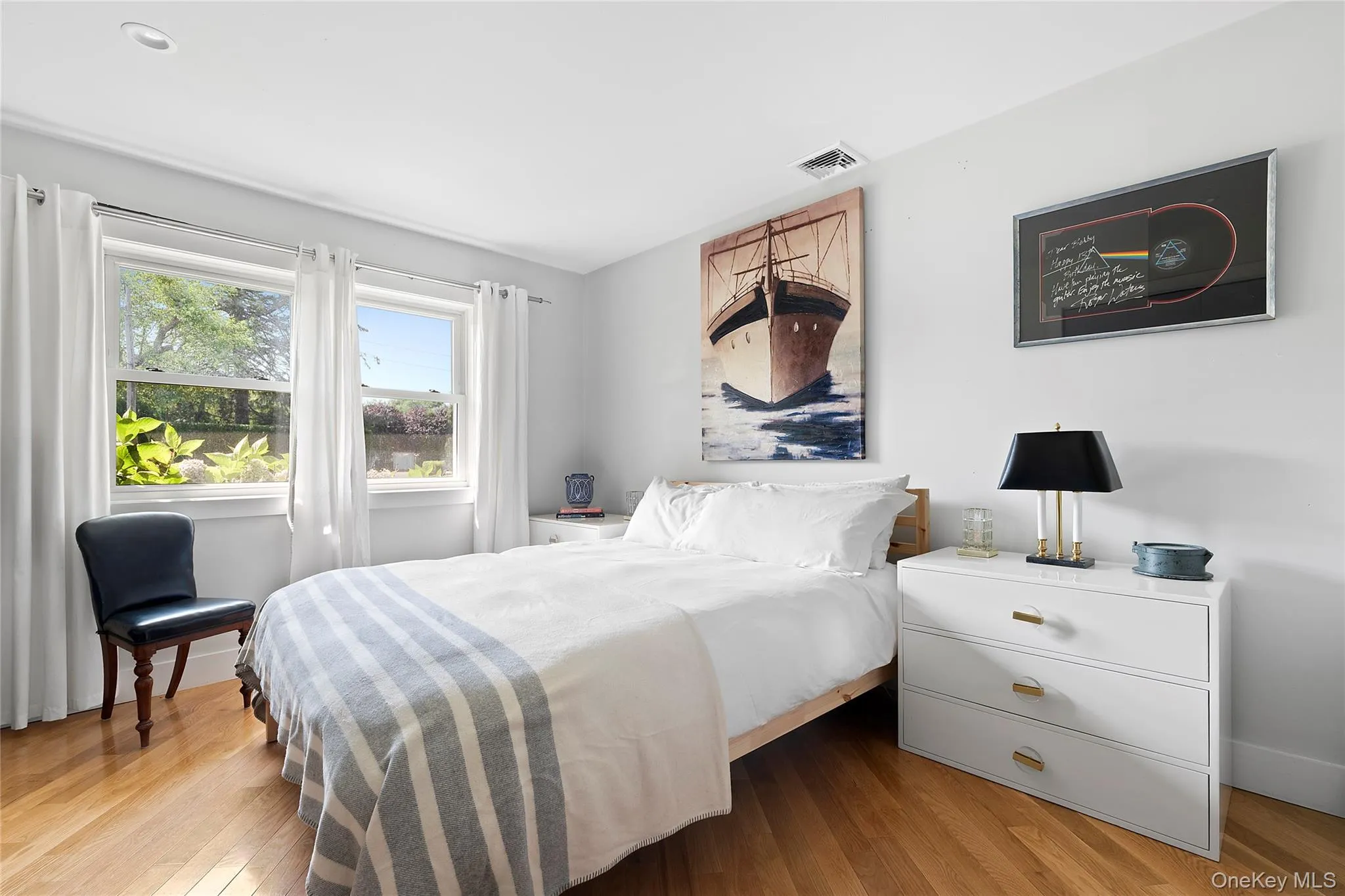 Bedroom featuring wood finished floors Bedroom featuring wood finished floors