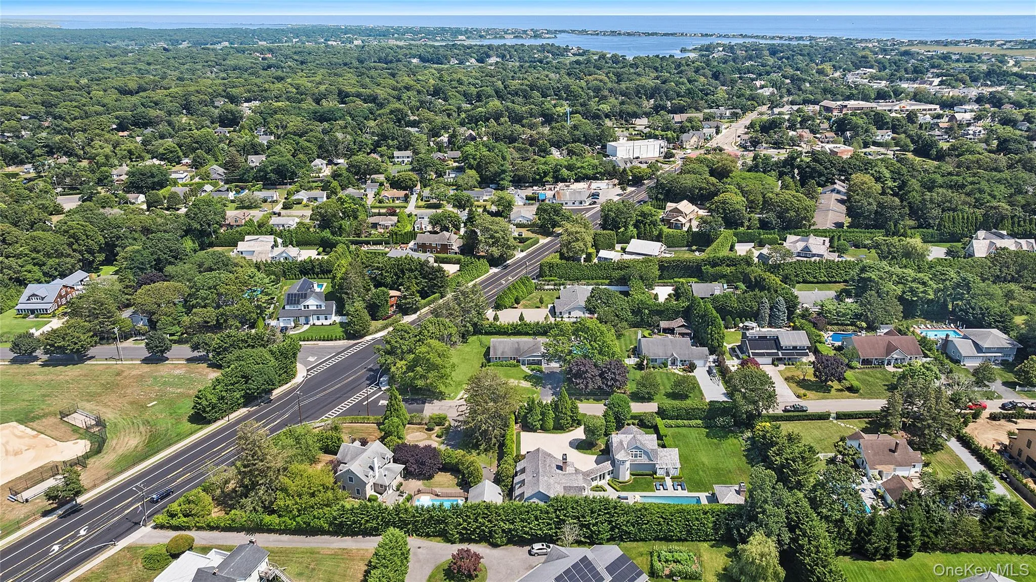 View of property location featuring a nearby body of water and nearby suburban area View of property location featuring a nearby body of water and nearby suburban area