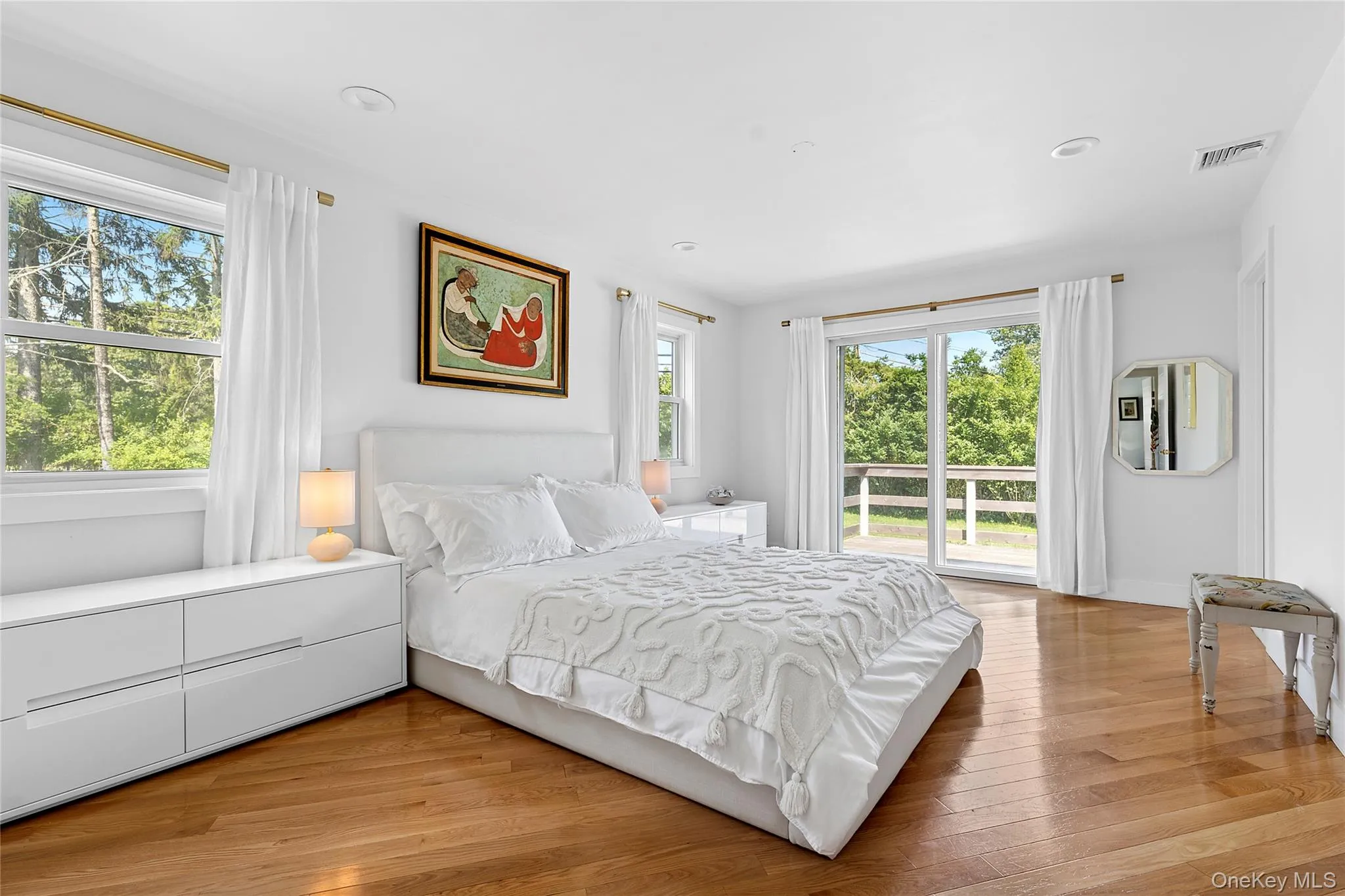 Bedroom featuring light wood-style flooring, access to exterior, and recessed lighting Bedroom featuring light wood-style flooring, access to exterior, and recessed lighting