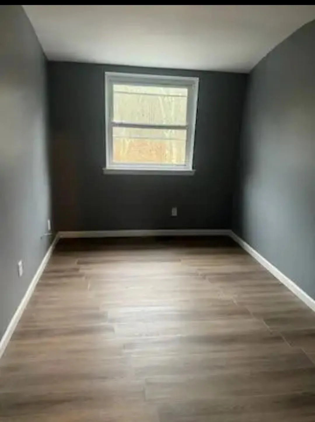 Empty room with wood finished floors and baseboards Empty room with wood finished floors and baseboards