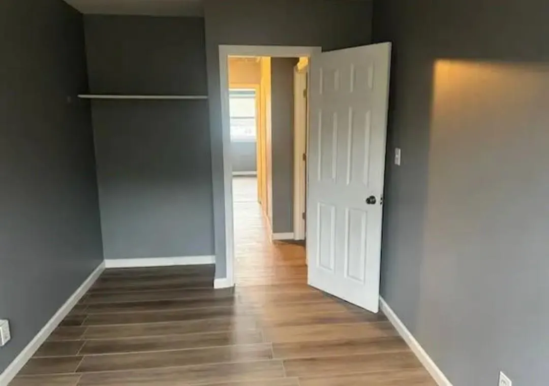 Unfurnished bedroom with wood finished floors and baseboards Unfurnished bedroom with wood finished floors and baseboards
