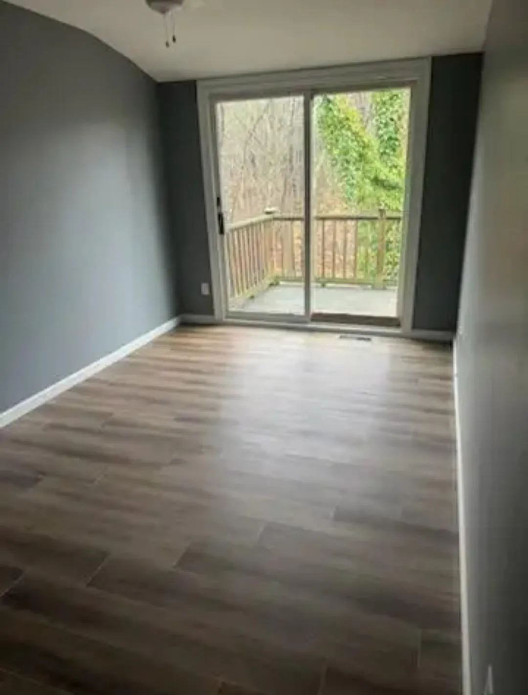 Unfurnished room featuring wood finished floors and healthy amount of natural light Unfurnished room featuring wood finished floors and healthy amount of natural light