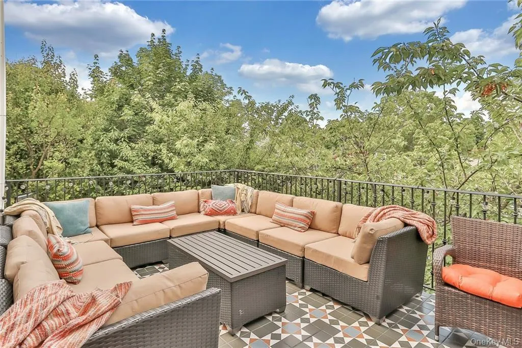 View of patio / terrace featuring an outdoor hangout area and a wooded view View of patio / terrace featuring an outdoor hangout area and a wooded view