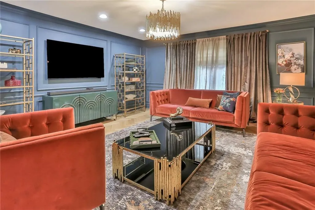 Living room featuring a decorative wall, a chandelier, and recessed lighting Living room featuring a decorative wall, a chandelier, and recessed lighting